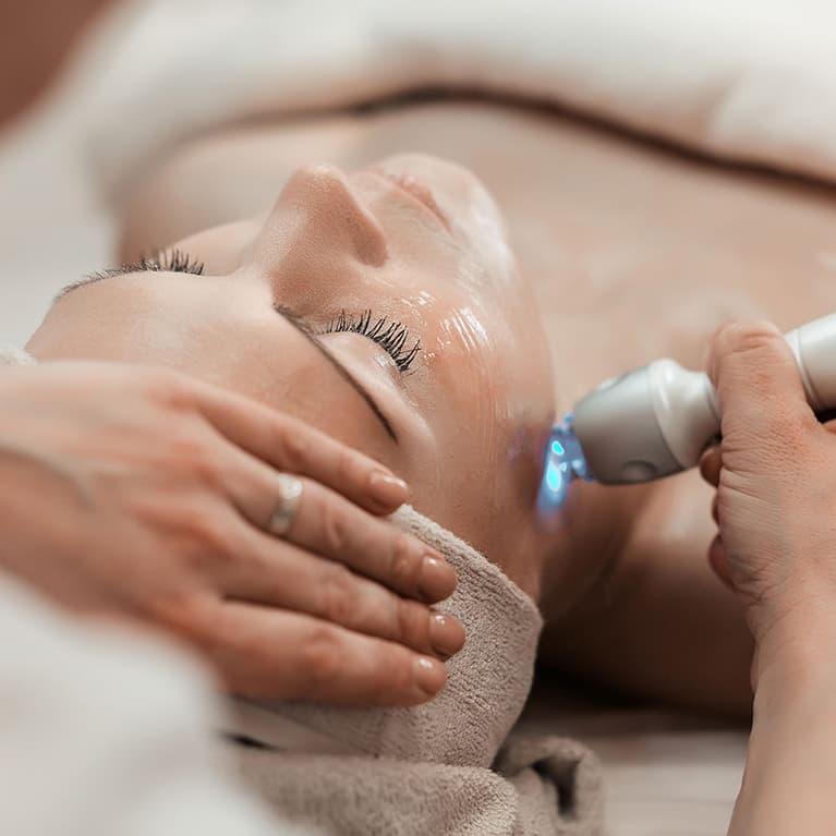 Woman recieving laser skin rejuvenation treatment