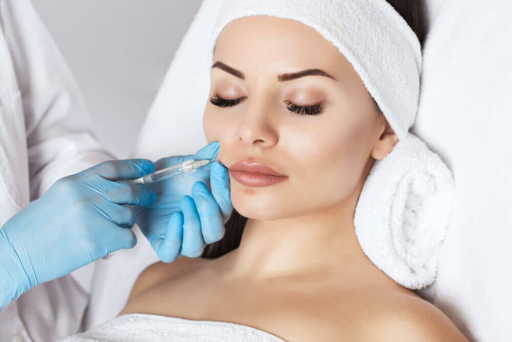 Woman on treatment table getting face injection