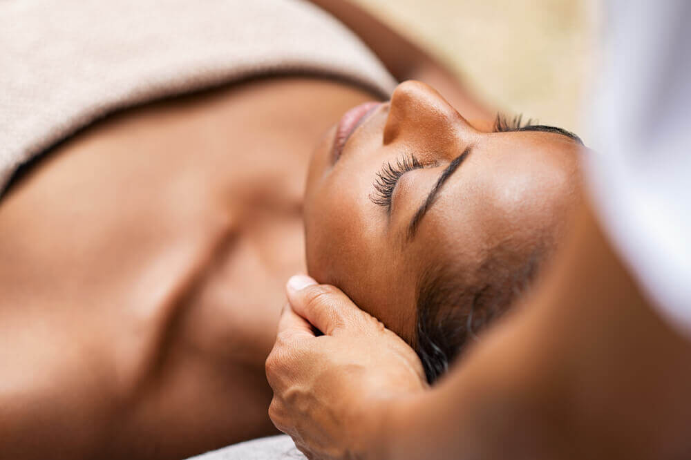 Woman with eyes closed on treatment table