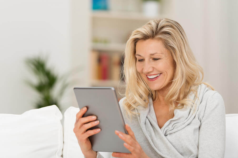 mature woman looking at tablet